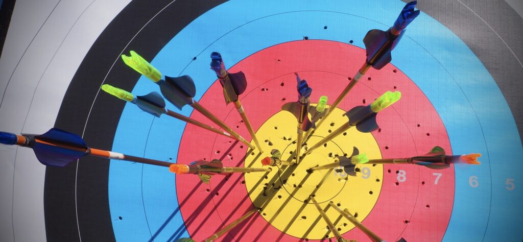 Archery target with lots of arrows in it